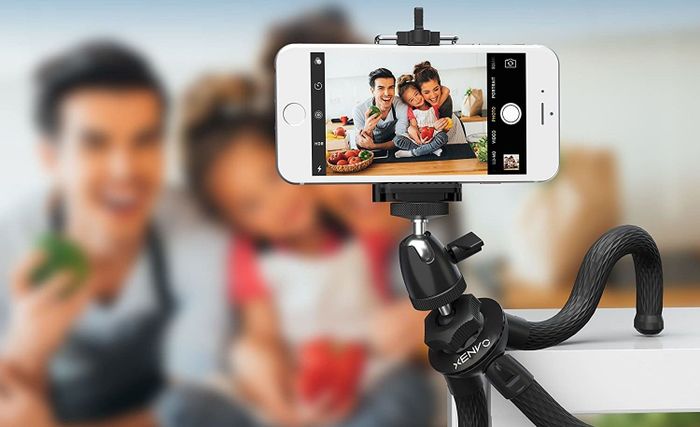 A family sets up and captures a photo using the tripod mount.