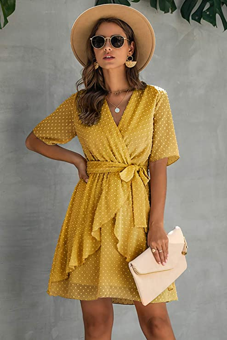 A model wearing a short-sleeve yellow faux-wrap dress, exuding elegance with ease.