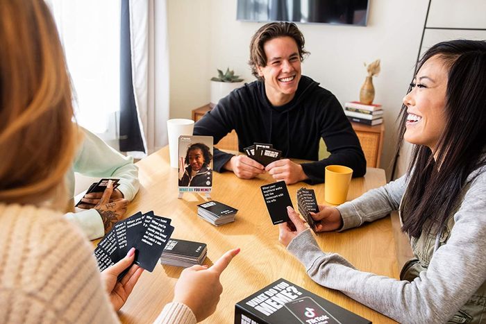 A group of friends enjoy a lively game of cards together.
