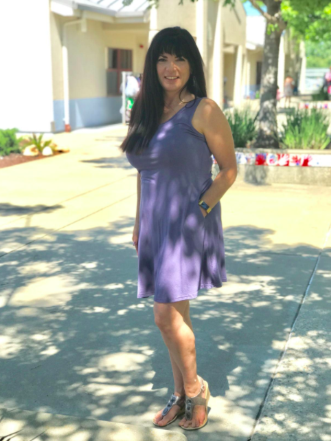 A reviewer is seen in the dress in a rich purple-gray color.