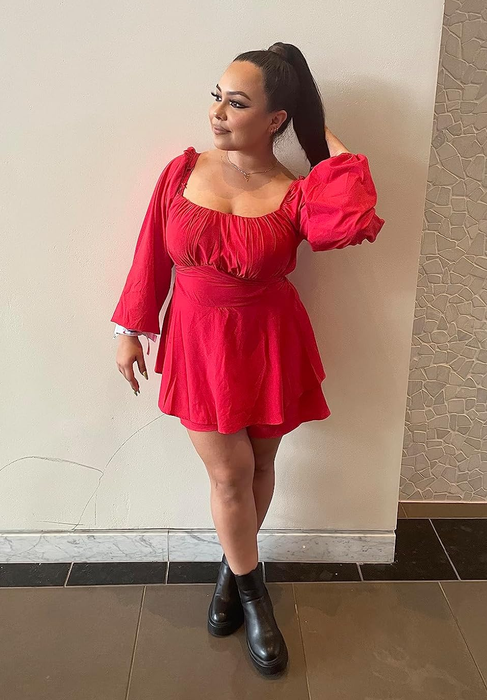 A reviewer showing off the red romper look