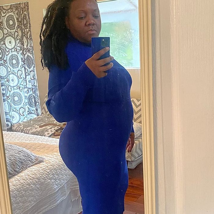 A reviewer wearing a blue dress