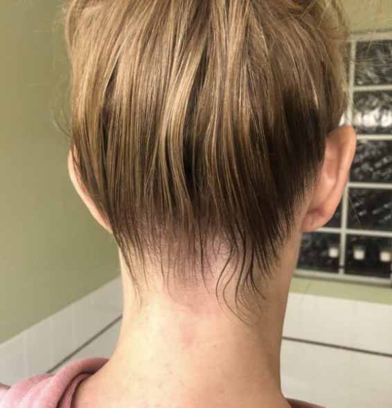 A reviewer displays their hair after applying the finishing stick.