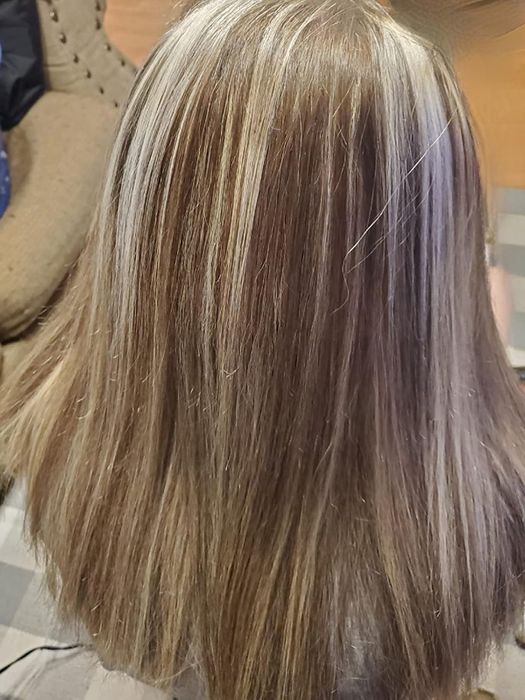 The back of the reviewer’s hair, appearing soft and shiny