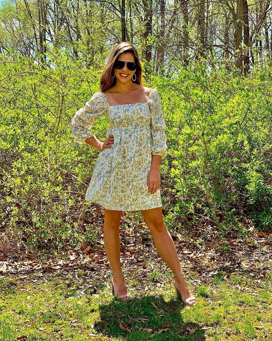 A reviewer rocking the floral print dress paired with heels