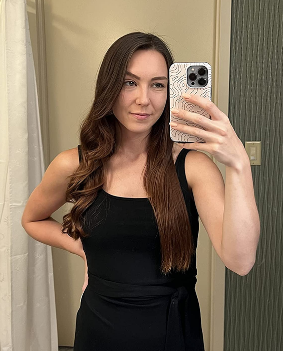 A reviewer with one side of their hair curled and the other side straightened