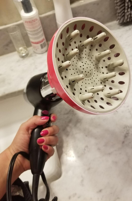Reviewer’s hair dryer fitted with the diffuser attachment.