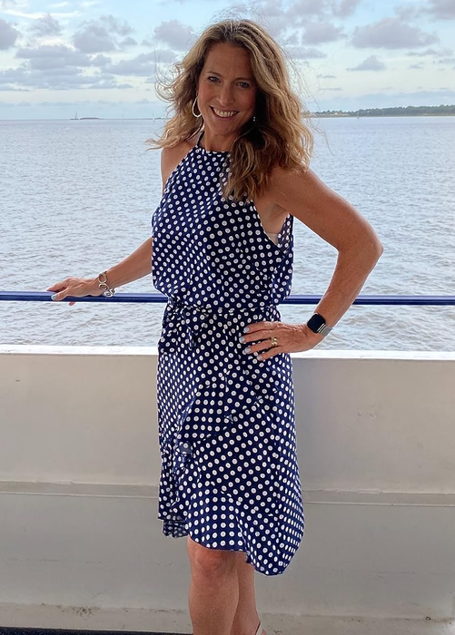 A reviewer in a navy dress