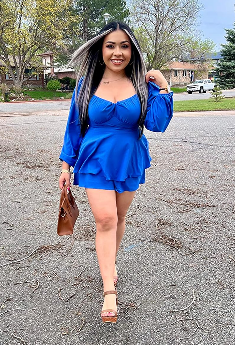 A reviewer sporting the blue romper