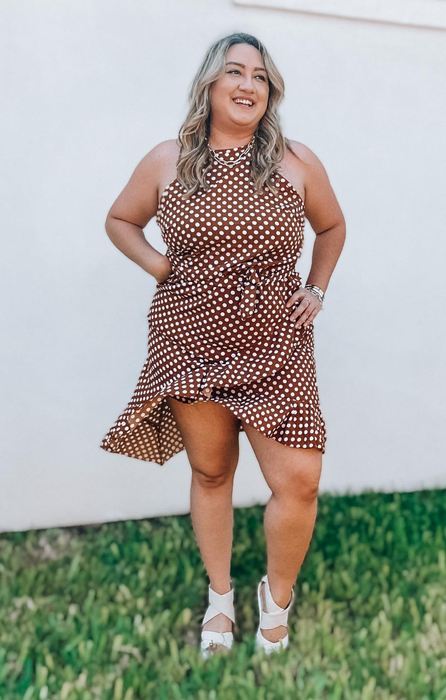 A reviewer in a brown dress