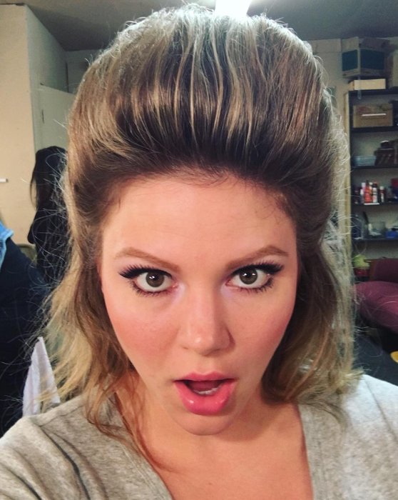 A reviewer proudly displays their big, teased hair.