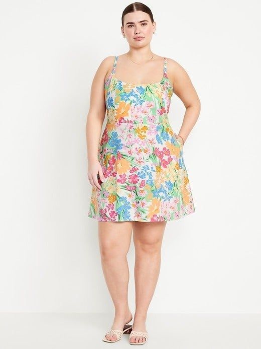 A model showcasing a multicolored flower print mini dress