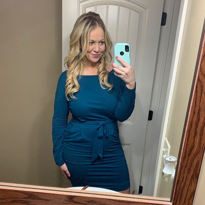 Reviewer sporting a stylish blue dress.