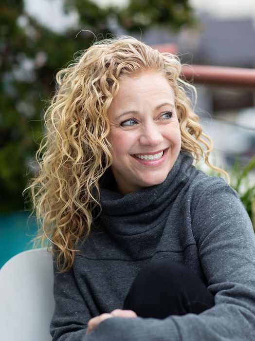Reviewer with curly blonde hair.