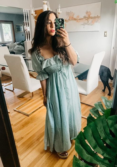 A reviewer wearing the mint green ruffled short-sleeve dress