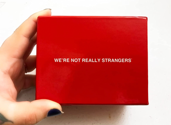 A reviewer holding a red box with the text displayed on it