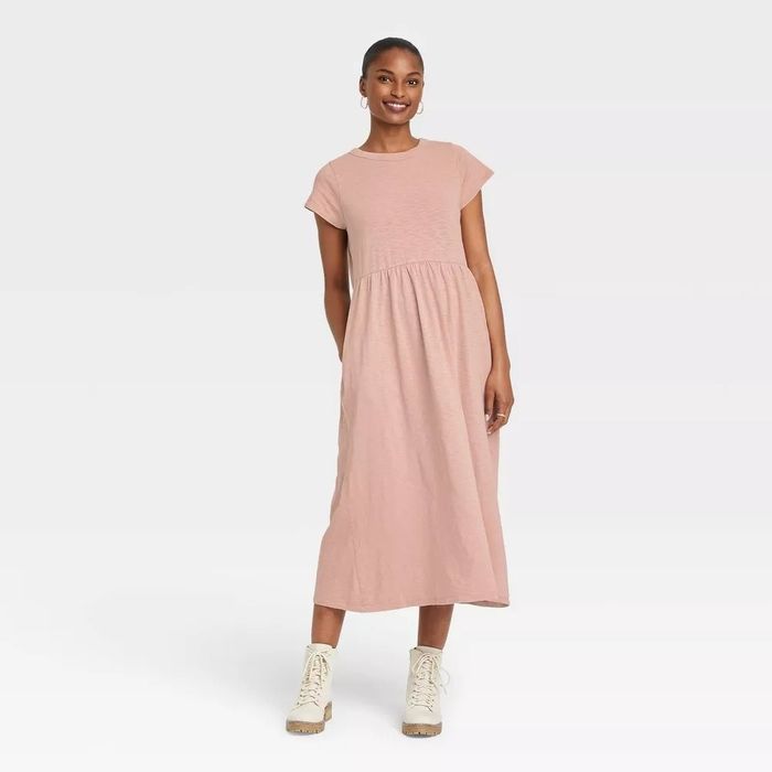 A model wearing a pink short-sleeve midi T-shirt dress