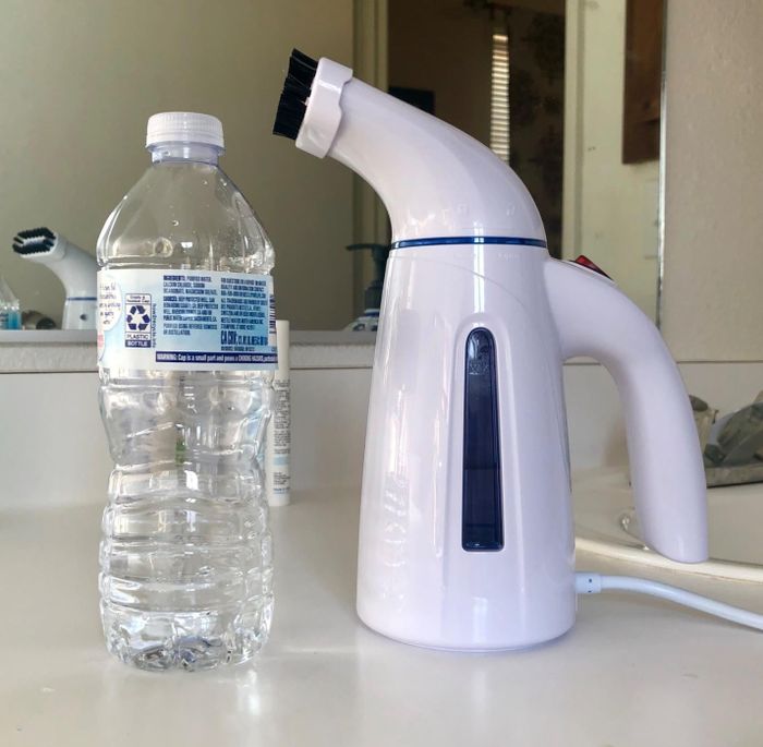 Reviewer displays a photo of the steamer beside a water bottle.