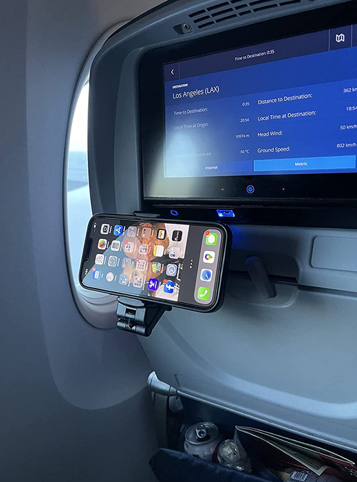 a photo from a reviewer showing the phone mount securely attached to their stowed tray table