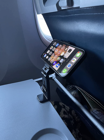 another photo from the same reviewer featuring the phone mount attached to their folded tray table