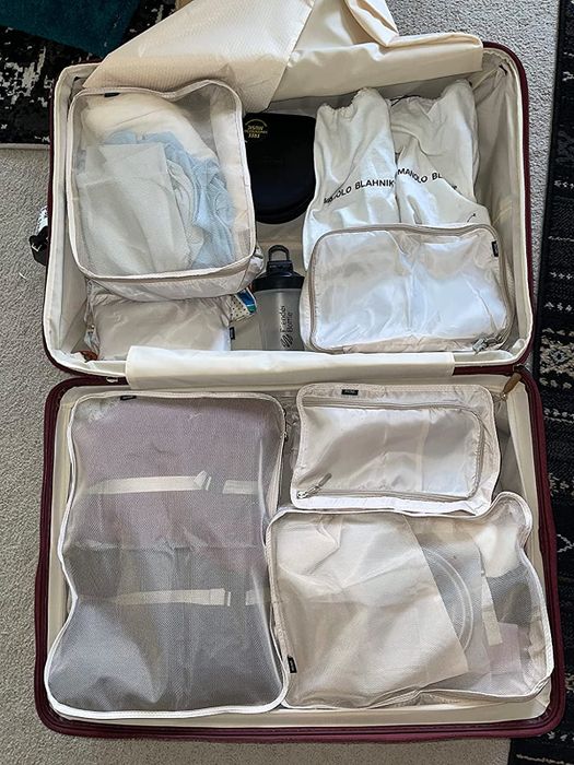 A set of packing cubes neatly arranged inside a suitcase.