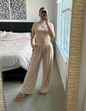 A reviewer dressed in the cream-colored version of the set with short sleeves.