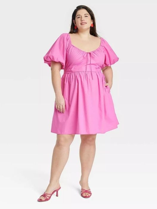 model wearing a short-sleeve pink puff mini dress