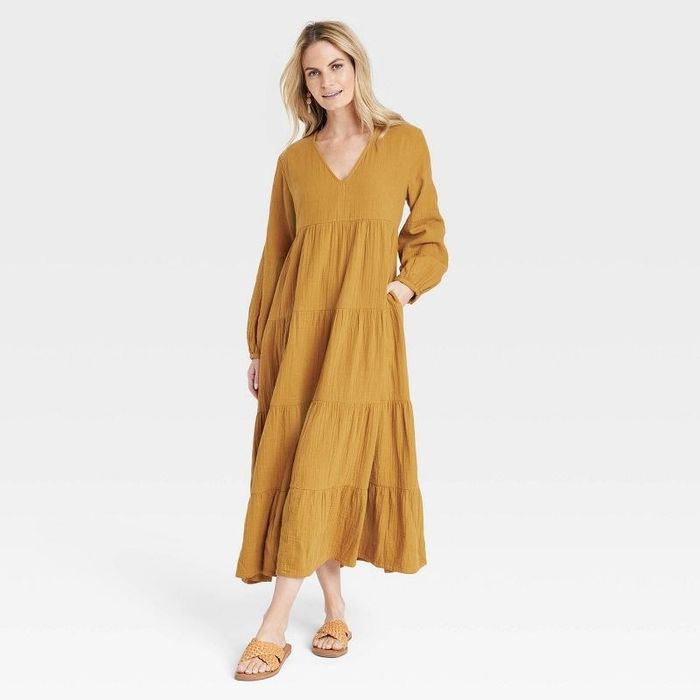 A model in the brown dress paired with flats