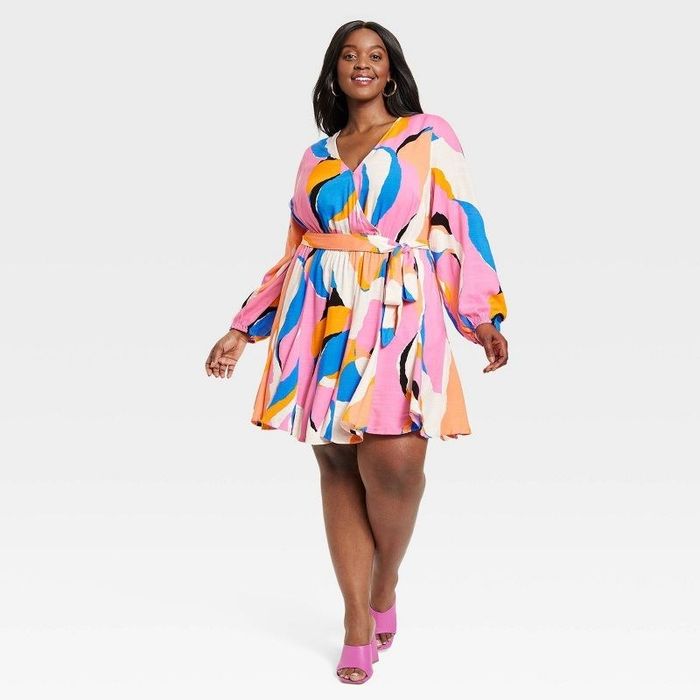 A model showcasing the dress in a vibrant multicolor design