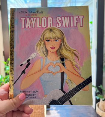 The illustrated cover of Taylor Swift making a heart gesture with her hands