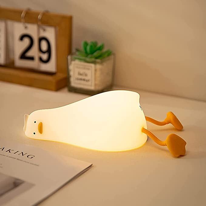 A glowing duck lying on its side, displaying a face full of pure, existential despair