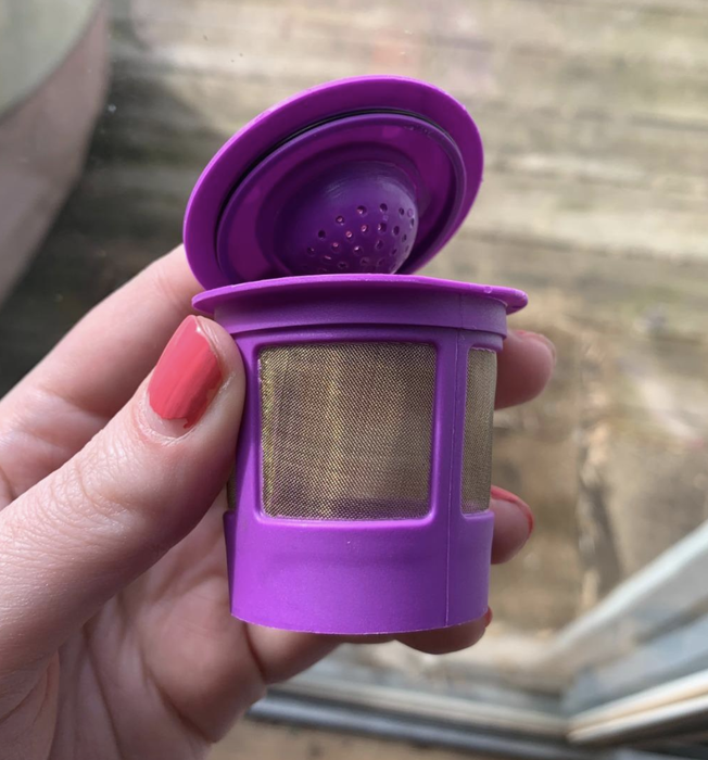 A reviewer showing off the purple reusable filter.