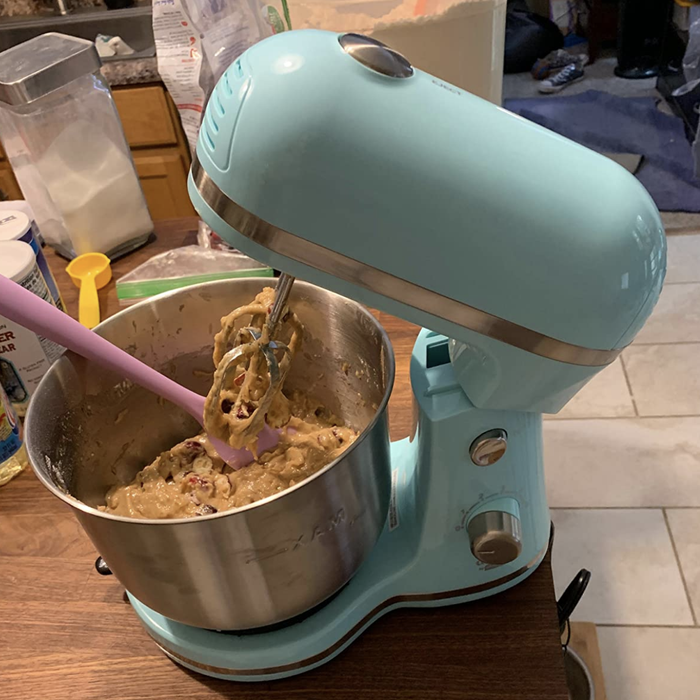 reviewer photo of the blue stand mixer mixing up batter