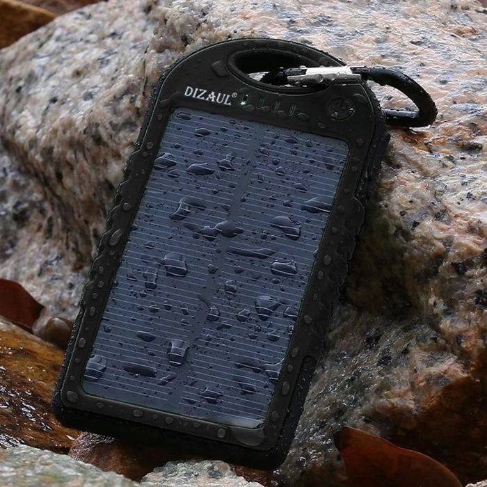 solar power bank with water droplets and a carabiner attached