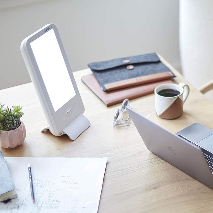 The rectangle-shaped light resting on the counter, accompanied by a pour-over coffee.
