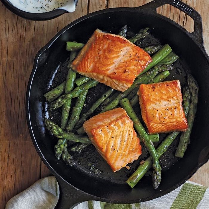 The black skillet with salmon and asparagus.