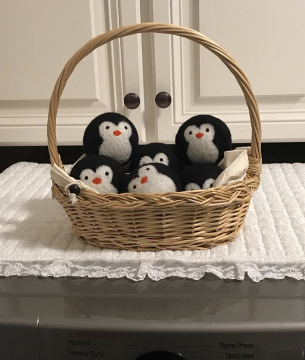 dryer balls arranged in a basket, neatly stacked atop the reviewer's dryer