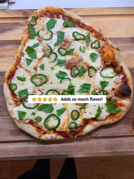 A reviewer’s freshly baked pizza with five stars and the note 'adds so much flavor'.