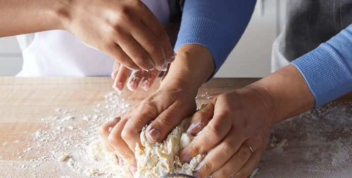 Hands working the dough.
