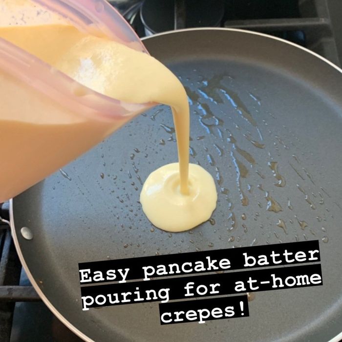 Pouring crepe batter easily from the container into a greased pan.