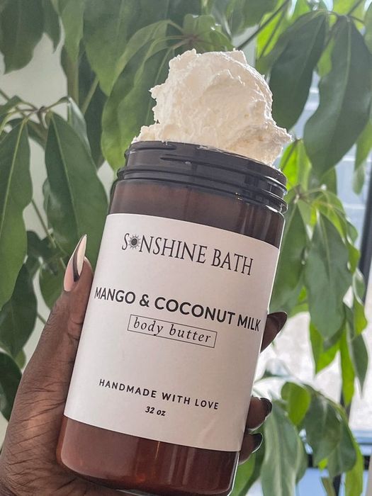 A model holding a brown jar of the luxurious whipped body butter.