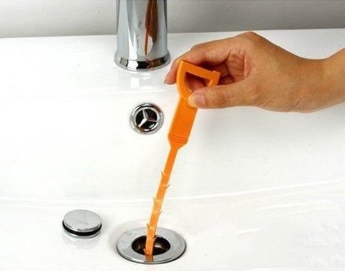 The snake being inserted into a sink drain.