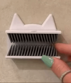 A reviewer using the device to gather hair and remove it.