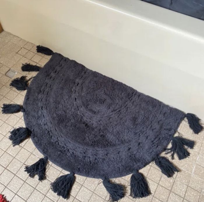 A reviewer's blue bath mat