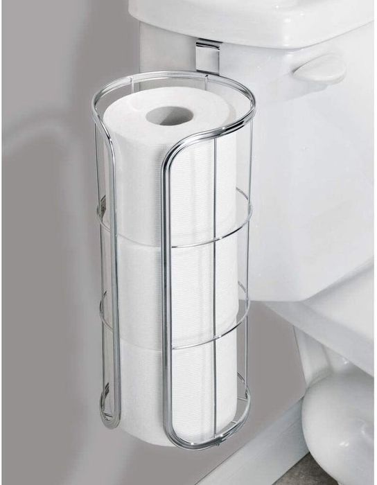 The TP holder hanging from the toilet bowl with three rolls neatly stored inside.