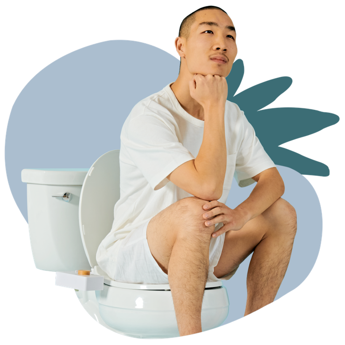 A model sitting on a toilet equipped with a bidet