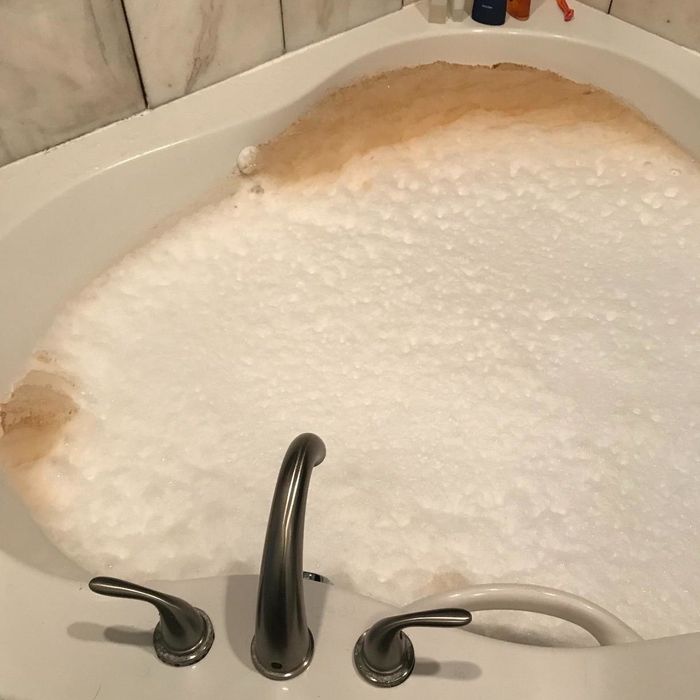 A reviewer's photo showing their jetted bathtub expelling brown, dirty water.