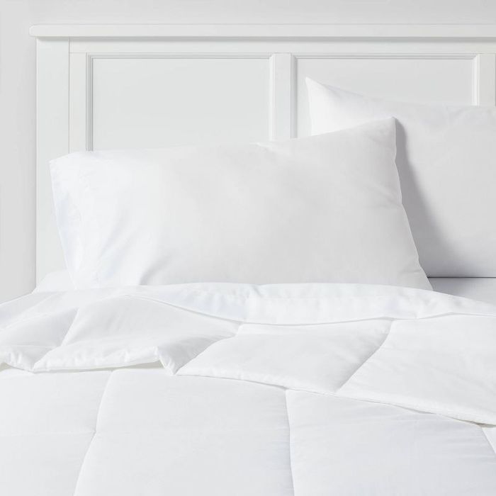 the duvet neatly arranged on a bed