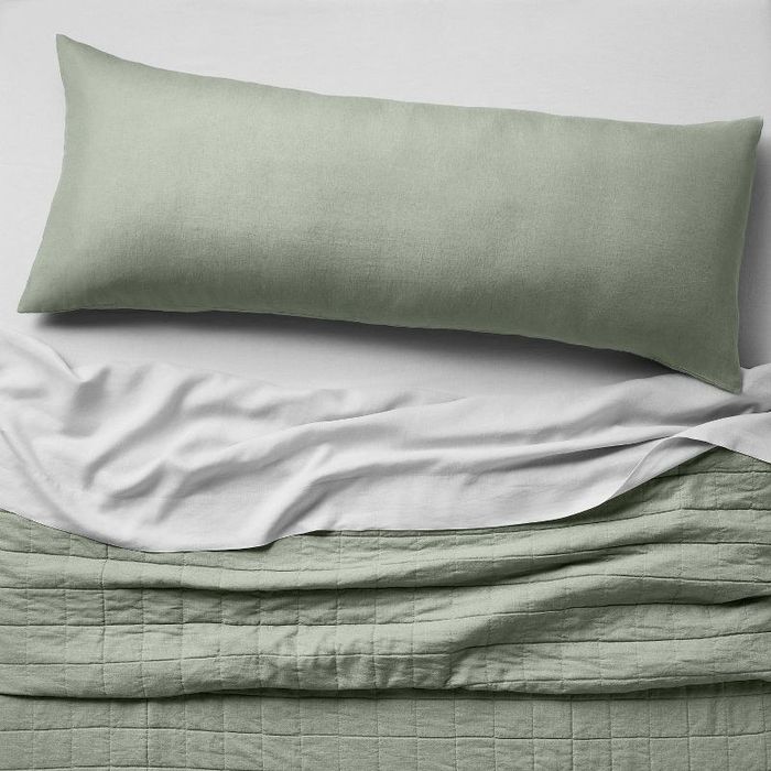 the sage green cover on a body pillow