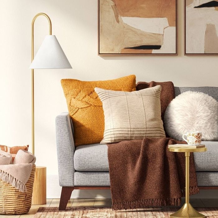 the round throw pillow resting on a couch